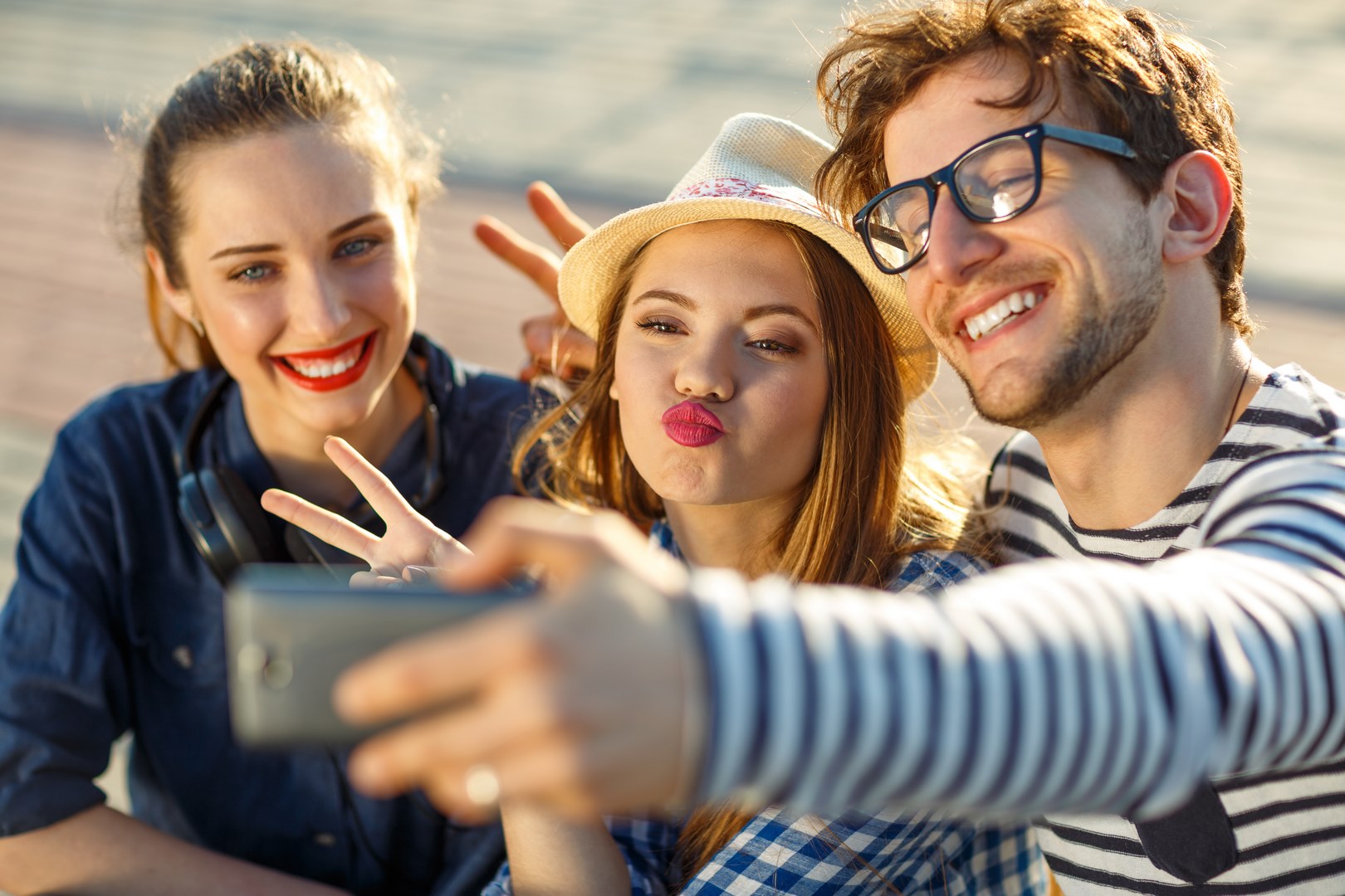 Smiling friends making selfie outdoors
