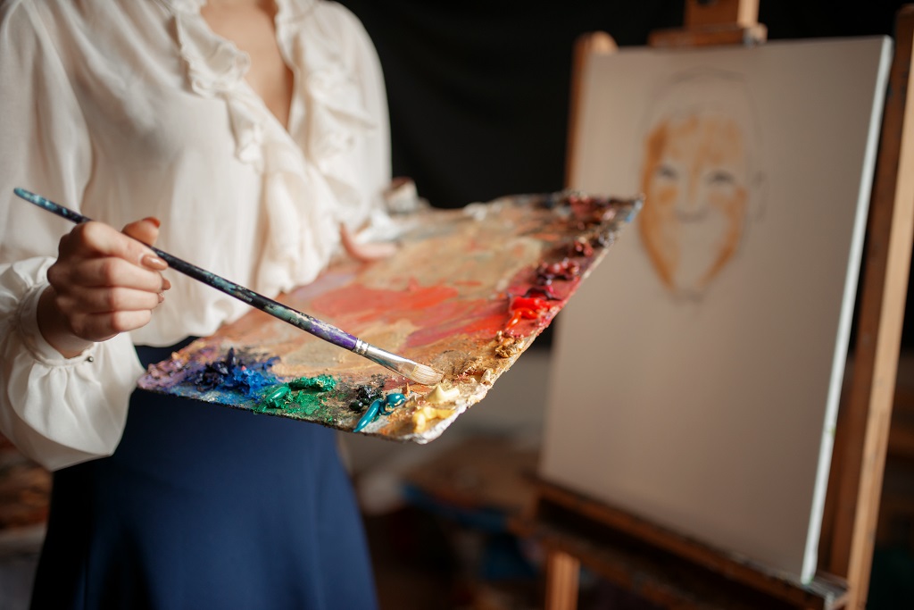Female artist with color palette and brush