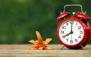 Daylight savings, spring forward concept - red alarm clock and a
